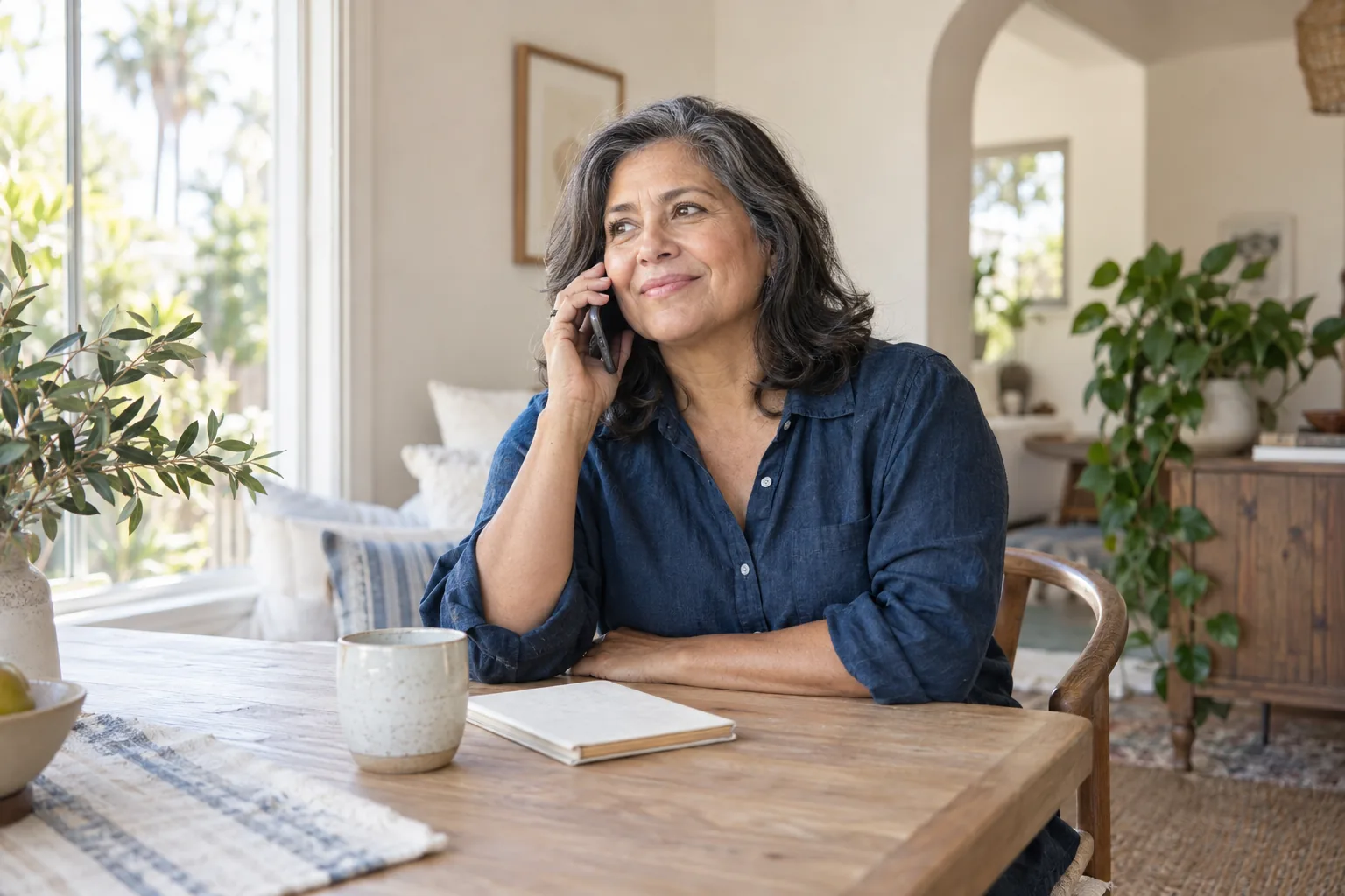 Illustrative scene of a woman having a relaxed phone conversation at home.